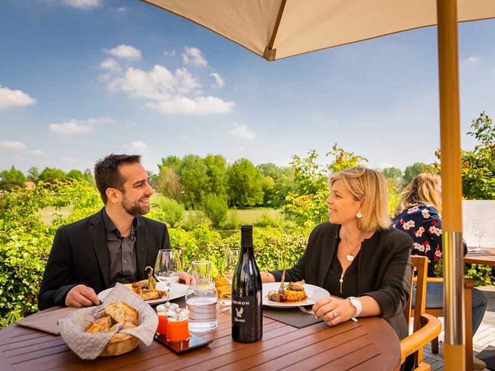 a couple enjoys french specialities 