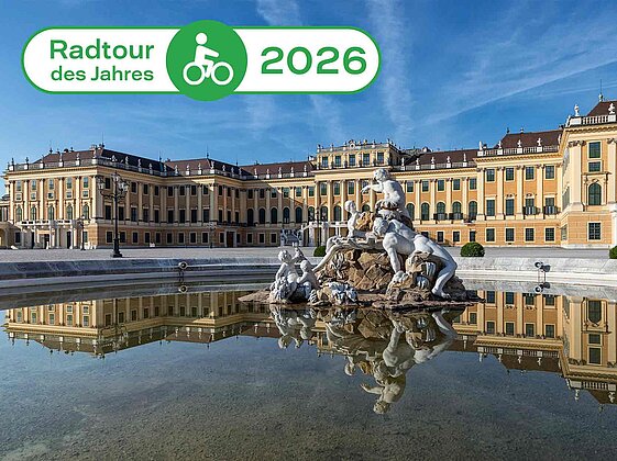 Außenansicht Schloss Schönbrunn mit Störer im Bild "Tour des Jahres 2026" 