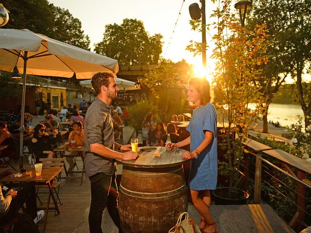 a couple enjoys a glass of wine outdoor